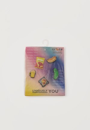 Five Crocs Jibbitz charms shaped like a hot dog, potato chips, beer mug, grilled fish, and pickle on colorful packaging.