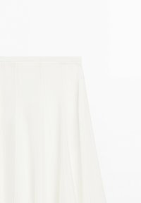 White high-waisted midi skirt with front pleats and an elastic waistband on a plain white background.