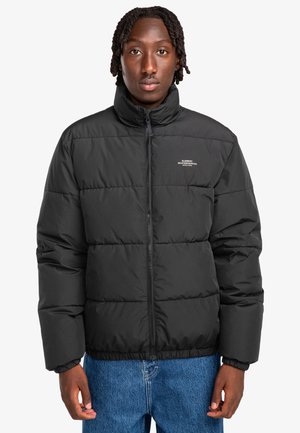 Black puffer jacket with a high collar, zip closure, and elastic cuffs. Features a quilted design and subtle branding on the chest.