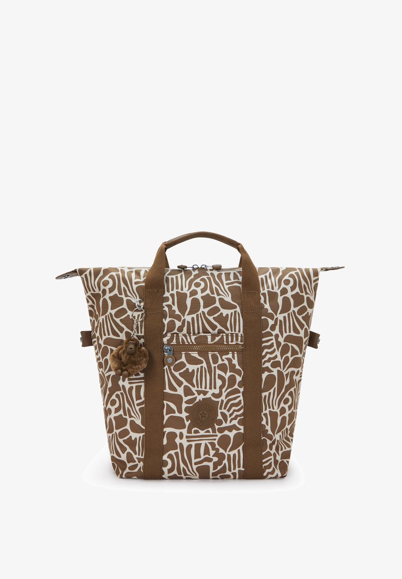 Brun og hvid mønstret stor taske med to håndtag, forreste lynlåslomme og en lille brun blød abe-nøglering fastgjort.