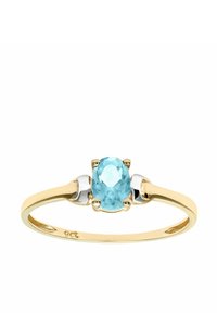 Anillo de oro con una piedra central ovalada de aguamarina, con acentos de plata a cada lado. El acabado suave y pulido realza el brillo.