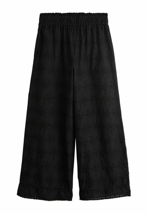 Schwarze Culottes mit elastischem Bund, versehen mit einem strukturierten Muster aus floralen Motiven, abgeschlossen mit einem wellenförmigen Saumdetail.
