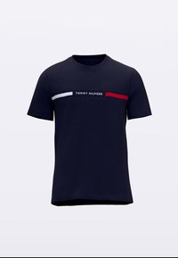 Tengerészkék rövid ujjú póló fehér és piros vízszintes csíkokkal a mellrészen, valamint a csíkok között középen "Tommy Hilfiger" felirattal.
