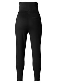 Svarta högmidjade leggings med en slät yta, figurnära passform och detalj med bakficka. Tyget verkar elastiskt och bekvämt.