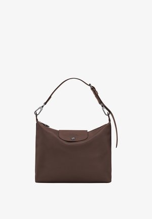 Brown leather shoulder bag with a top flap and silver button closure, featuring an adjustable strap with metal clasps.
