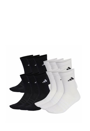 Eight pairs of Adidas crew socks, four black and four white, each with a small Adidas logo on the ankle.
