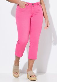 Růžové zkrácené džíny s úzk ým střihem, vyrobené z měkké látky, s předními kapsami a zipovým zapínáním, doplněné béžovými platformovými sandály.