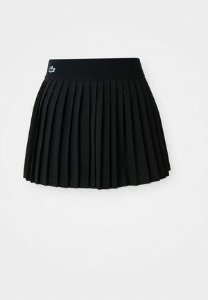 Svart plisserte skjørt med ribbet midje og grønt logo. Stoffet er glatt, med en strukturert, utsvingt form.