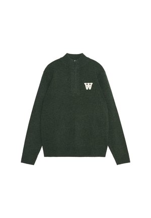 Green sweater with a high collar and quarter zip. Features a white "W" logo on the left chest. Made of a textured knit fabric.