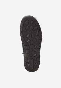 Suela de zapato de goma negra con un diseño de textura y agarre de múltiples patrones que presenta varias formas geométricas para proporcionar tracción y durabilidad.