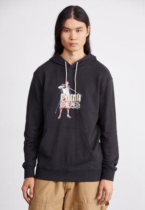 Black hoodie made of cotton with a front pocket. Features a colorful graphic print of a character holding a sword. Drawstring hood.