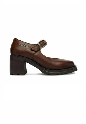 Brązowy skórzany but typu Mary Jane na grubym, blokowym obcasie, z regulowanym paskiem na klamrę i logo G-STAR po boku.
