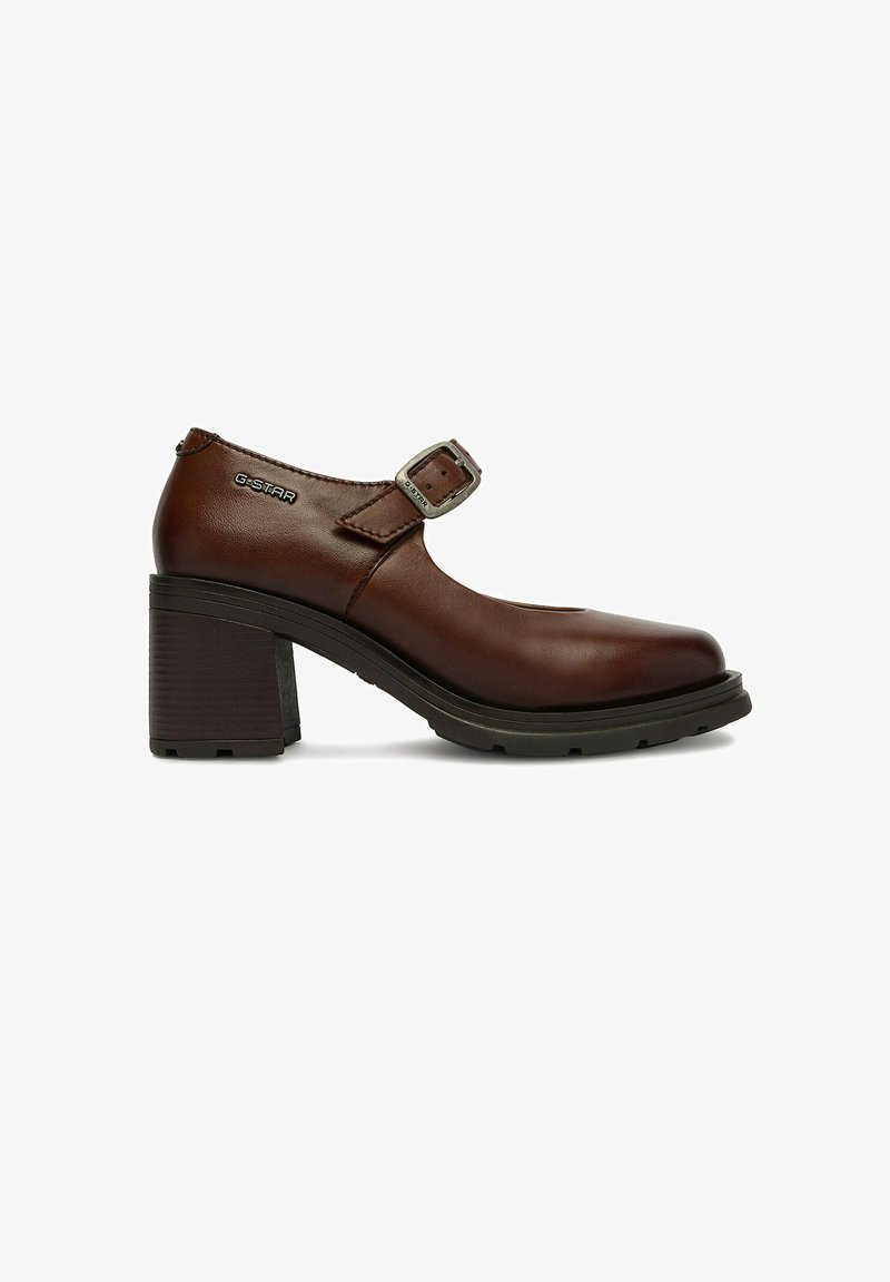 Zapato Mary Jane de cuero marrón con tacón grueso y ancho, correa ajustable con hebilla y logo de G-STAR en el lateral.