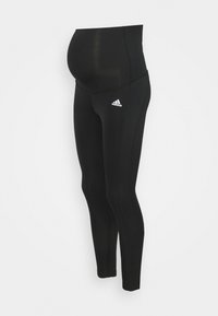 Leggings de maternidade pretos feitos de tecido elástico, com uma cintura larga, um corte slim e o logo da Adidas no lado esquerdo.