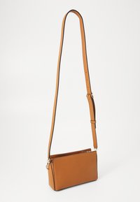 Brown leather crossbody bag with a textured finish, slim rectangular shape, adjustable strap, and silver hardware accents.