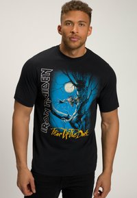 Černé bavlněné tričko s modrošedou grafikou kosterní postavy v roce, se tekstem "Iron Maiden" a "Fear of the Dark".