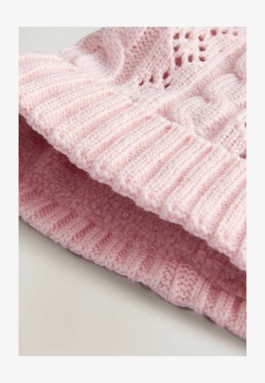 Gebreide roze beanie met een geribde rand en kabelpatroon. Zachte textuur, met opengewerkte details die de ademend vermogen verbeteren.
