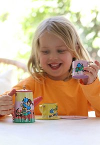 Colorful metal tea set features a pink-striped teapot and yellow cup with playful illustrations. Smooth texture and sturdy design enhance usability.