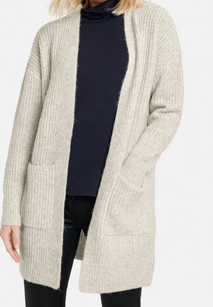Cardigan en tricot gris clair avec une coupe ample, un devant ouvert et deux poches avant. Tissu texturé avec des détails côtelés.