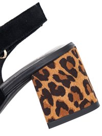 Black suede ankle strap sandal with block heel covered in leopard print fabric.