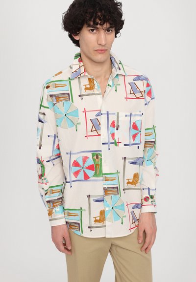 Short-sleeve button-up shirt with a cream fabric featuring colorful beach-themed patterns, including umbrellas and lounge chairs.