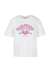 Balta medvilninė marškinėliai su rožine grafika, kurioje yra užrašas "HAMPTONS ATHLETICS 1891" ir dvi kryžiuojančios raketės. Trumpomis rankovėmis, apvali kaklo iškirptė.