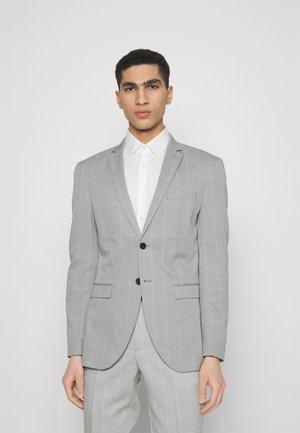 Gray checkered blazer with a structured fit, single-button closure, notch lapels, and two front pockets, paired with a white shirt.