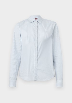 Light blue striped long-sleeve shirt made of cotton, featuring a pointed collar, button closure, and an embroidered logo on the chest.