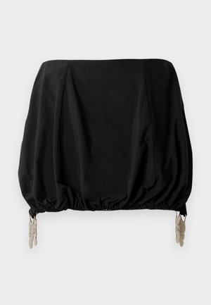 Black cropped top with a gathered design, featuring elastic hem and metallic clips as accents. Made from a lightweight fabric.