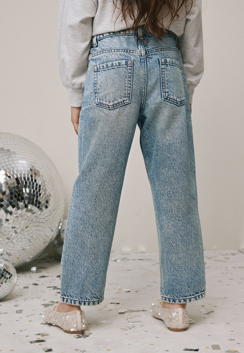 Jeans din denim cu spălare deschisă, talie înaltă, croială largă pe picior și două buzunare în spate, asortate cu papuci confortabili cu paiete.