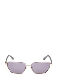 Gafas de sol hexagonales con lentes ahumados en gris, armazón de metal dorado y patillas de plástico gris. Cuenta con almohadillas nasales transparentes y el logotipo de la marca en el costado.