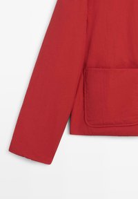 Rote Jacke mit glatter Textur, ausgestattet mit einer eckigen Fronttasche und gerade geschnittenem Ärmel. Einfaches Design und einfarbig.