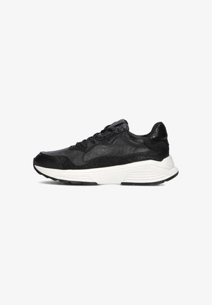 Black sneaker with textured leather and mesh upper, white midsole, black outsole, and lace-up design. Subtle accents of shine detail.