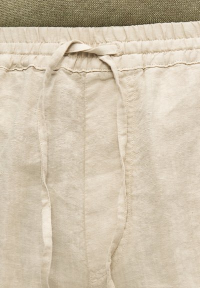 Μπεζ παντελόνι από λινό με ελαστική μέση και διακριτική υφή. Διαθέτει καθαρό, απλό σχέδιο με ραμμένες ραφές.