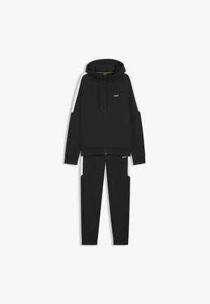 Black hoodie with front zip, drawstring, and logo, paired with matching black sweatpants featuring side pockets and contrasting accents.