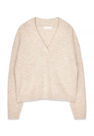 Beige knitted sweater with a deep V-neck, wide sleeves, and cropped design. The texture is soft and slightly flecked. No fastenings.