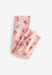 Leggings rosa piegati con un motivo floreale che presenta piccoli fiori rosa, arancioni e bianchi e foglie verdi su sfondo bianco.