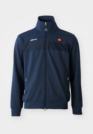Navy blue zip-up jacket with high collar, featuring black panel accents, front pockets, and embroidered logo detail in orange and yellow.