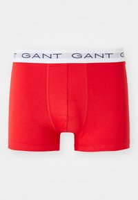 Red men's boxer briefs with a white elastic waistband featuring the brand name "GANT" in navy blue letters.