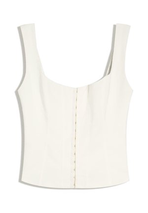 Haut blanc sans manches de style corset avec fermetures à crochets devant et larges bretelles.