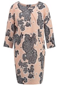 Printed dress with a loose fit, featuring a light peach background and abstract black and grey shapes. Soft fabric and three-quarter sleeves.