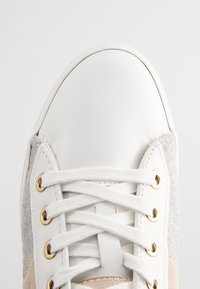 Sneaker bianca in pelle con accenti in suede grigio, lacci in cotone e occhielli dorati. Punta arrotondata con materiali e dettagli di cucitura a contrasto.