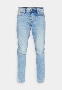 Light blue denim jeans with a slim fit, featuring a button closure, five pockets, and subtle fading throughout the fabric.