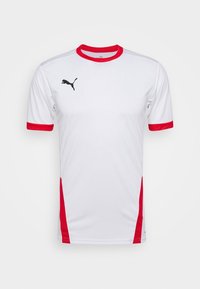 Hvid sportstrøje med rød krave og ærmekant, med en sort Puma-logo på brystet og sidedetalje for ekstra stil.