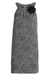 Mustavalkoinen pilkkuimmekko, jossa on olkaimeton muotoilu, ryppyneuletoppi ja musta kukka-akseli vasemmalla puolella. Teksturoitu kangas.