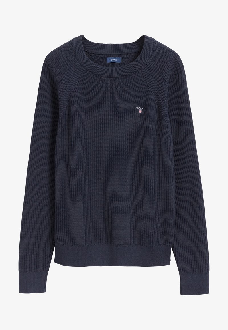 Pull marine côtelé avec un col rond et des manches longues. Il présente un petit logo brodé sur la poitrine et un motif en maille texturée.