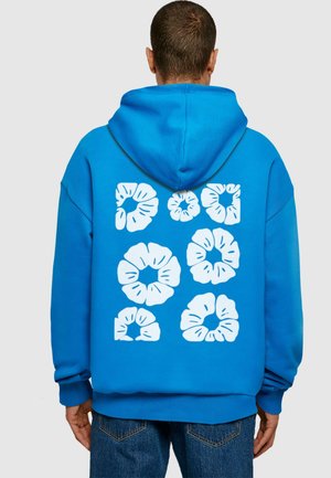 Blue hoodie with a large white floral graphic design on the back. Features a drawstring hood and ribbed cuffs for a relaxed fit.