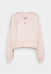 Ljusrosa kort sweatshirt i mjukt material, med dragsko-huva, svart Nike-logotyp och avslappnad passform med ribbade ärmmuddar.