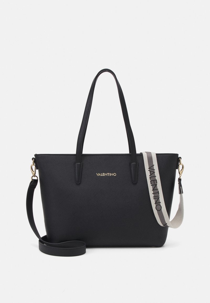Black leather tote bag with two top handles and a detachable shoulder strap. Features gold logo and textured finish. Functional and sleek design.