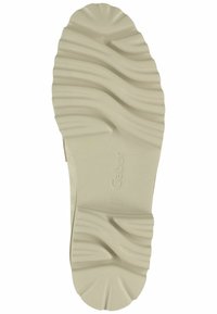 Semelle de chaussure couleur crème avec des motifs ondulés texturés et des rainures pour l'adhérence. Présente le marquage "Gabor" sur une surface plane.